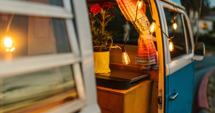 camper van with lights draped over the side door.