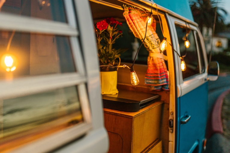 camper van with lights draped over the side door.