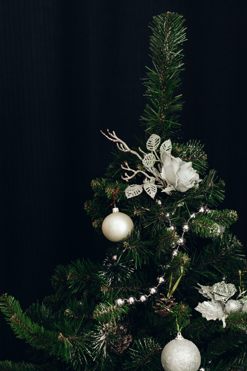 top of christmas tree with white decor