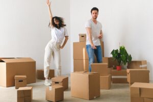 Couple dancing around moving boxes